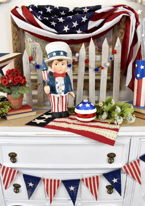 Red, white and blue banner drapes across the buffet for patriotic look. Sammys Star Spangled Banner Vignette